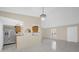 Bright living area featuring tile flooring, neutral paint, and a modern chandelier at 6209 Beaumont Ave, Orlando, FL 32808
