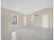 Bright living area featuring tile flooring, neutral paint, and an archway to other rooms at 6209 Beaumont Ave, Orlando, FL 32808