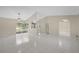 Bright living area featuring tile flooring, neutral paint, a chandelier, and sliding glass doors at 6209 Beaumont Ave, Orlando, FL 32808