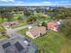 Scenic aerial view of the community featuring cozy houses, verdant lawns and mature trees at 6766 Edgeworth Dr, Orlando, FL 32819
