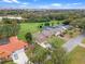 Overhead shot of the property with a spacious lawn and surroundings, highlighting its location near a golf course at 6766 Edgeworth Dr, Orlando, FL 32819