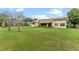 Large, well-kept backyard with lush green grass and mature trees, offering a serene outdoor space at 6766 Edgeworth Dr, Orlando, FL 32819