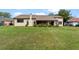 Expansive backyard featuring a well-maintained lawn and a view of the home's rear facade at 6766 Edgeworth Dr, Orlando, FL 32819