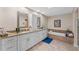 Luxurious bathroom with double vanity, granite countertops, and a soaking tub, creating a spa-like retreat at 6766 Edgeworth Dr, Orlando, FL 32819