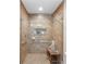 Accessible shower with glass door, bench, and grab bars for added safety and convenience at 6766 Edgeworth Dr, Orlando, FL 32819