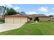 Charming single-story home with a spacious three-car garage and well-manicured landscaping at 6766 Edgeworth Dr, Orlando, FL 32819