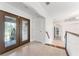 Bright foyer featuring marble flooring, glass paneled double doors, and white trim accents at 6766 Edgeworth Dr, Orlando, FL 32819