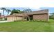 Well-maintained one-story home with manicured lawn and mature landscaping, offering curb appeal at 6766 Edgeworth Dr, Orlando, FL 32819