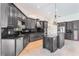 Spacious kitchen with dark cabinetry, granite counters, stainless steel appliances, and a central island at 6766 Edgeworth Dr, Orlando, FL 32819