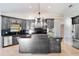 An open kitchen features black cabinets, granite countertops, a central island, and stainless steel appliances at 6766 Edgeworth Dr, Orlando, FL 32819