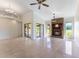 Spacious living room with fireplace, tile floors, ceiling fan, and sliding glass doors to the outside at 6766 Edgeworth Dr, Orlando, FL 32819