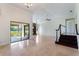 A well lit open floor plan featuring travertine tile, fireplace and sliding glass doors to the lanai at 6766 Edgeworth Dr, Orlando, FL 32819