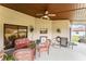 Covered patio featuring ceiling fan, comfortable wicker furniture, and a view of the lush backyard at 6766 Edgeworth Dr, Orlando, FL 32819