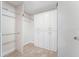 Bright walk-in closet featuring built-in storage and hanging racks at 6766 Edgeworth Dr, Orlando, FL 32819