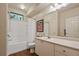 Bright bathroom featuring a shower-tub combo, vanity with sink, and tile flooring at 911 N Orange Ave # 148, Orlando, FL 32801
