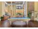 Spacious game room offers a pool table, kitchenette, and exposed brick wall for entertainment at 911 N Orange Ave # 148, Orlando, FL 32801
