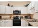 Modern kitchen with white cabinets and stainless steel appliances, ideal for cooking and entertaining at 911 N Orange Ave # 148, Orlando, FL 32801