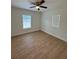 Bedroom with two windows, new flooring, and a ceiling fan at 1007 Colyer St, Orlando, FL 32805