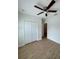 A bright bedroom with wood-look flooring, ceiling fan, and a closet at 1007 Colyer St, Orlando, FL 32805