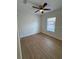 A bright bedroom with wood-look flooring, ceiling fan, and a window at 1007 Colyer St, Orlando, FL 32805