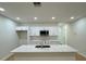 Kitchen island with a sink, white cabinets, and stainless steel microwave at 1007 Colyer St, Orlando, FL 32805