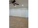 A living room with new flooring, a ceiling fan, and a sliding glass door at 1007 Colyer St, Orlando, FL 32805