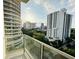 View of city buildings from condo balcony with glass railing at 101 S Eola Dr # 921, Orlando, FL 32801