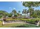 Beautiful community sign surrounded by lush landscaping and palm trees at 1043 S Hiawassee Rd # 3125, Orlando, FL 32835