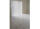 Bedroom featuring tiled floors and sliding glass door at 106 Dahlia Dr, Kissimmee, FL 34743