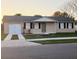 Charming single-story home featuring neutral paint, black shutters, and a well-maintained lawn at 106 Dahlia Dr, Kissimmee, FL 34743