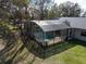 Aerial view of home with large backyard, in-ground pool and screened enclosure at 1157 Schooner Dr, Kissimmee, FL 34744