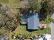 Aerial view of the house with a screened-in pool and mature landscaping at 1157 Schooner Dr, Kissimmee, FL 34744