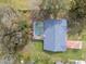 Aerial view of the house with a screened-in pool and mature landscaping at 1157 Schooner Dr, Kissimmee, FL 34744