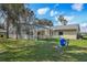 Backyard view featuring the screened in pool and exterior of home at 1157 Schooner Dr, Kissimmee, FL 34744