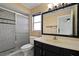 Bathroom featuring a glass door shower, neutral color walls and a framed mirror at 1157 Schooner Dr, Kissimmee, FL 34744