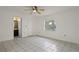 Bedroom featuring tile flooring, a window, and ensuite bathroom at 1157 Schooner Dr, Kissimmee, FL 34744