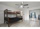 Bedroom featuring a bunkbed, ceiling fan, and mirrored closet at 1157 Schooner Dr, Kissimmee, FL 34744