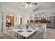 Dining room features a marble table with seating for six, and an open view to the kitchen and living area at 1157 Schooner Dr, Kissimmee, FL 34744