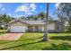 Charming single-story home with brick accents, well-maintained lawn, and attached two-car garage at 1157 Schooner Dr, Kissimmee, FL 34744