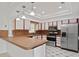 Well-lit kitchen with white cabinetry, stainless steel appliances, and tiled countertops at 1157 Schooner Dr, Kissimmee, FL 34744