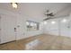 Bright and airy living room features tiled floors, a large window, and a freshly painted white walls at 1157 Schooner Dr, Kissimmee, FL 34744