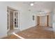 Bright living room featuring white walls, terracotta tile floors, and double french doors at 1157 Schooner Dr, Kissimmee, FL 34744