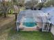 An elevated shot of a screened-in pool with lounge chairs next to the house at 1157 Schooner Dr, Kissimmee, FL 34744