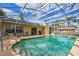 Screened pool area showcasing ample seating, a grill, and a sparkling refreshing pool at 1157 Schooner Dr, Kissimmee, FL 34744