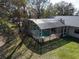 Aerial view of a screened-in pool and backyard area with mature trees at 1157 Schooner Dr, Kissimmee, FL 34744