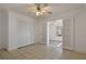 Bright room featuring tile floors, closet, French doors, and ceiling fan at 1157 Schooner Dr, Kissimmee, FL 34744