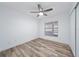 Bright bedroom with a ceiling fan, window and light wood laminate flooring at 1188 La Mesa Ave, Winter Springs, FL 32708