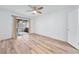 Bedroom featuring a ceiling fan, light wood laminate flooring and sliding glass doors to lanai at 1188 La Mesa Ave, Winter Springs, FL 32708