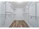 Walk-in closet with light wood laminate flooring and wire shelving at 1188 La Mesa Ave, Winter Springs, FL 32708