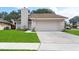 Charming home featuring a manicured lawn, driveway, and welcoming facade at 1188 La Mesa Ave, Winter Springs, FL 32708